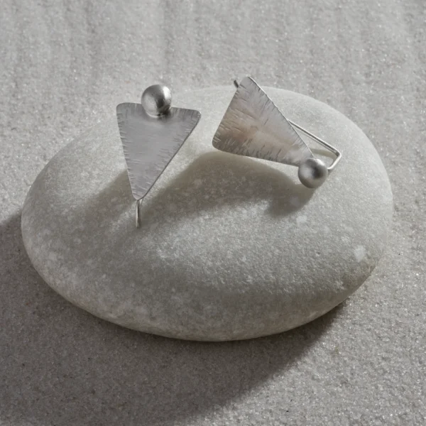 Handmade silver earrings, with a triangular shape.