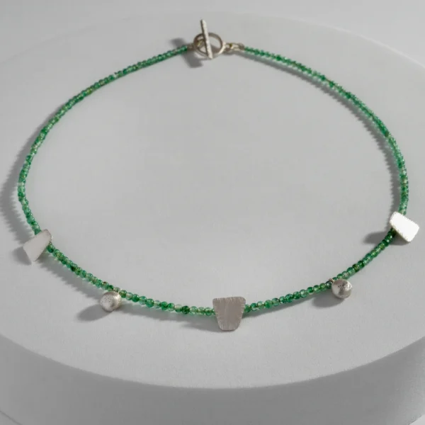 Boho Jade necklace with green jade beads and handmade sterling silver elements in varied shapes and textures.
